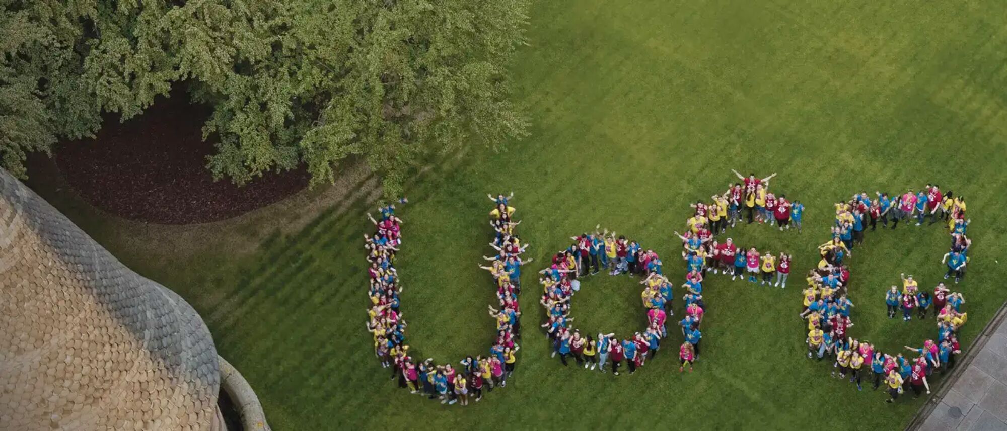 Aerial shot of UofG letters made up by students standing in formation