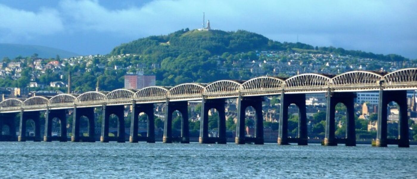 A view of Dundee railway bridge with the city of Dundee and Law Hill in the background