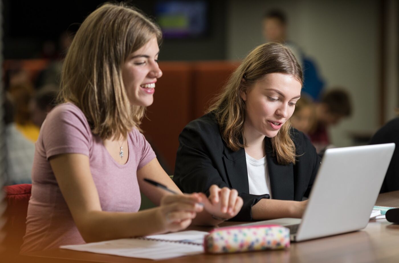 Two students working on laptops