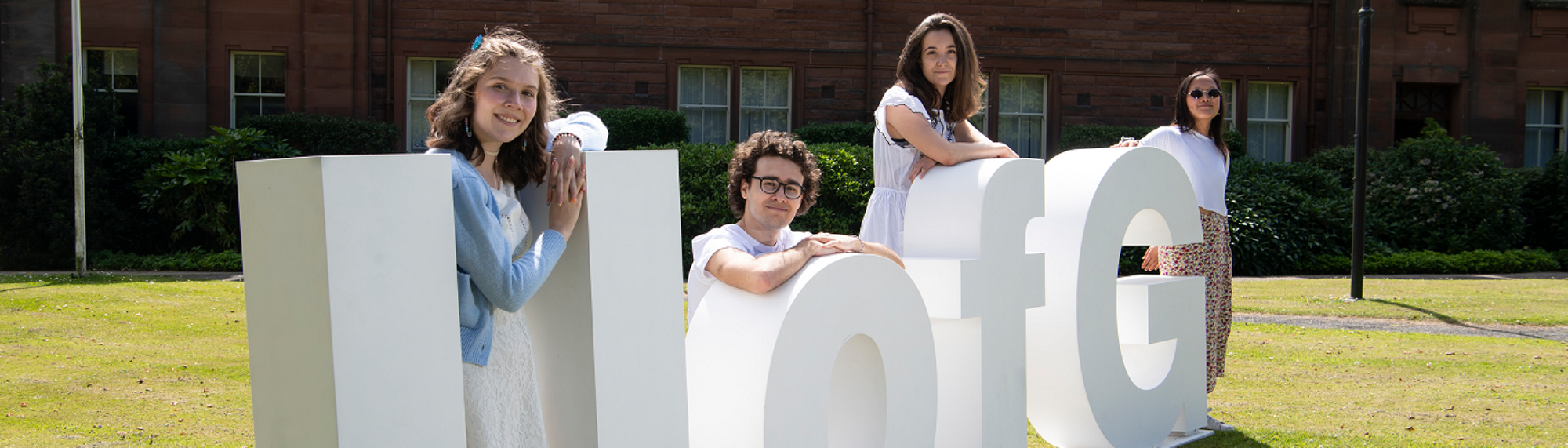 UofG Letters with Students sitting - 1400x400