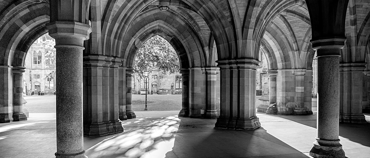 A black and white shot of the University of Glasgow cloisters.