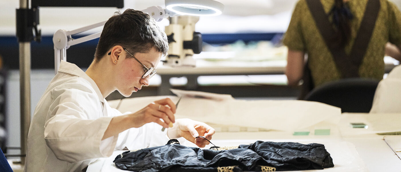 A student on the programme working on a garment in our lab.