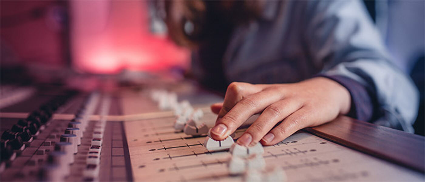 hands mixing audio in recording studio