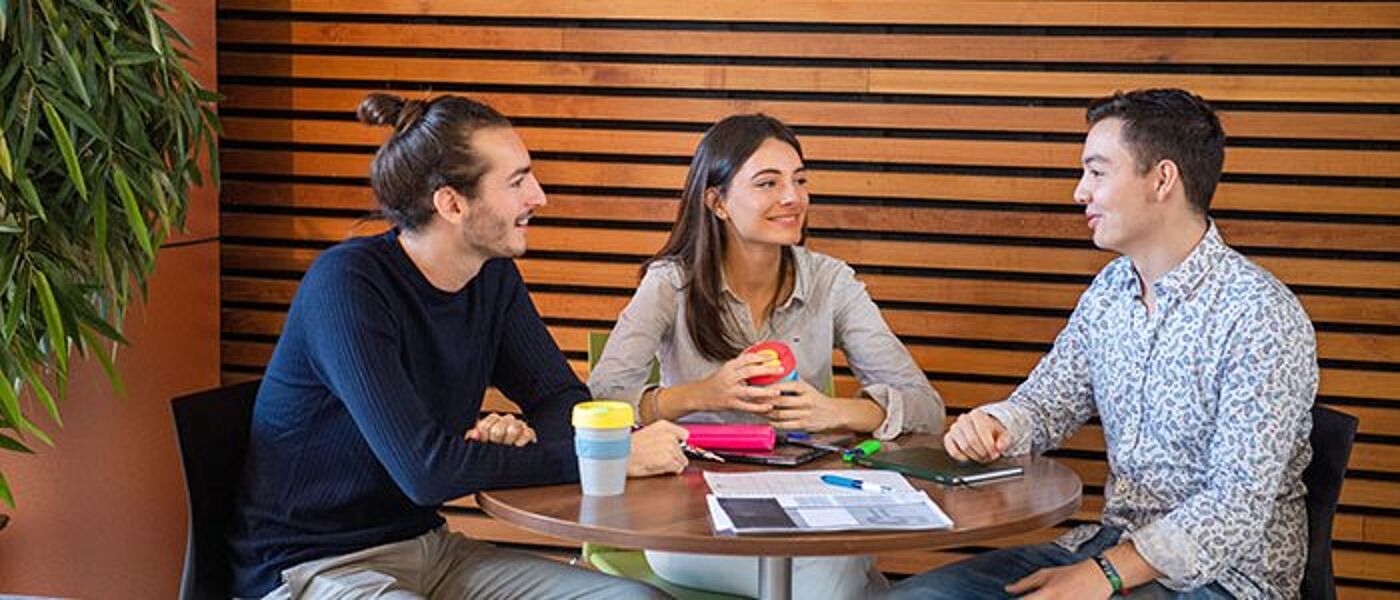 students smiling around a table