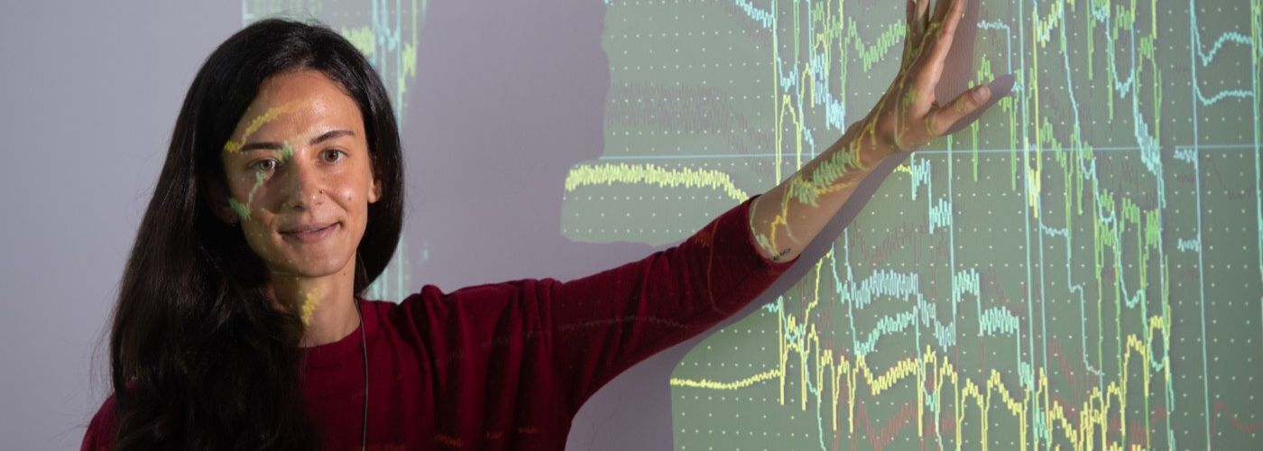 Woman standing in front of a projector