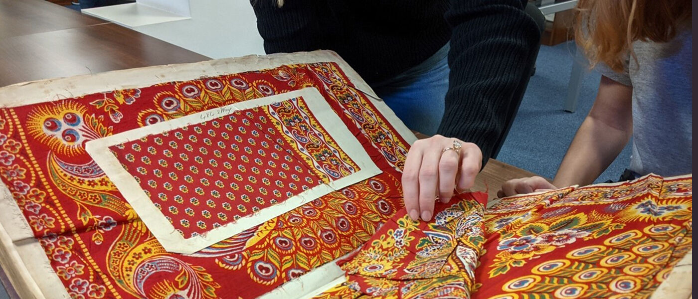 A woman browsing a book of fabric samples