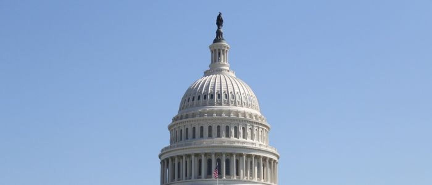 The dome of the US Capitol against a blue sky