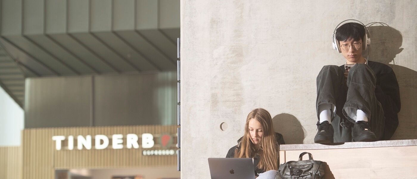 Students sitting on steps with laptops