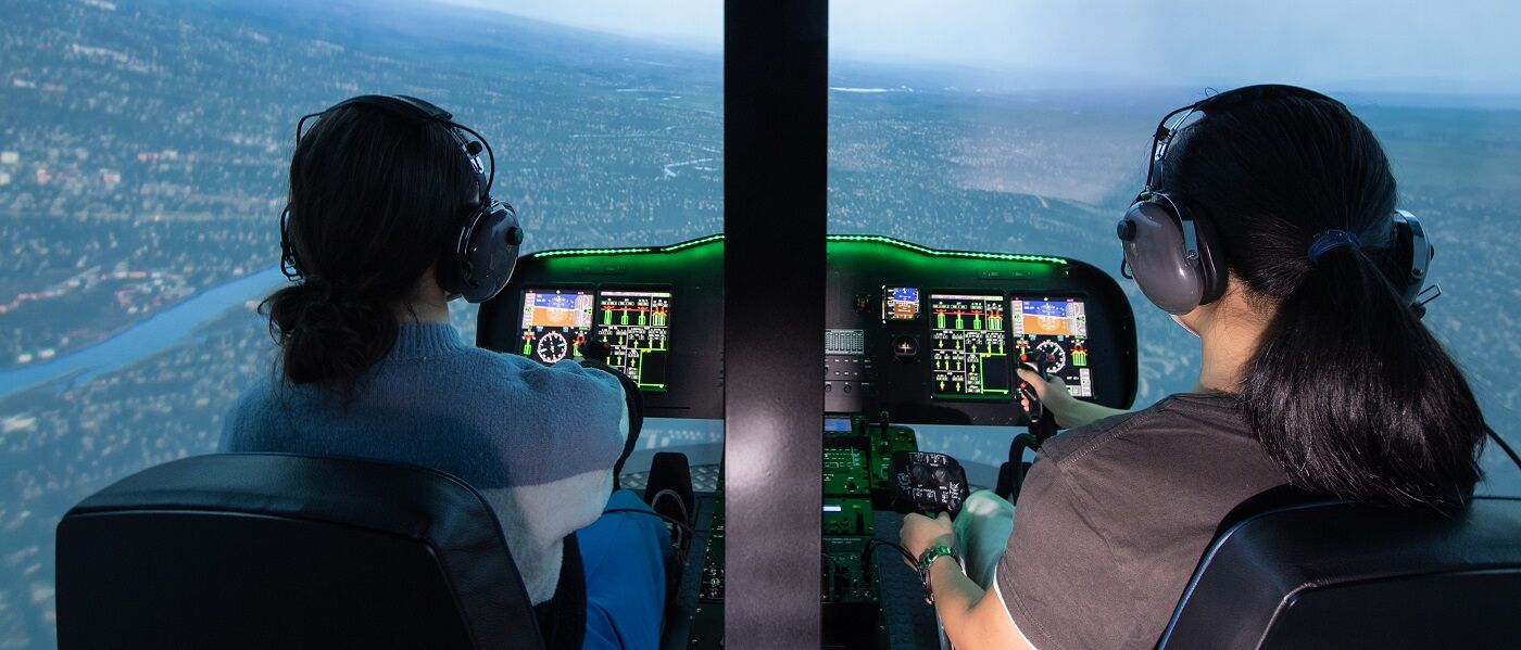 Two aeronautical engineering students in a flight simulator.
