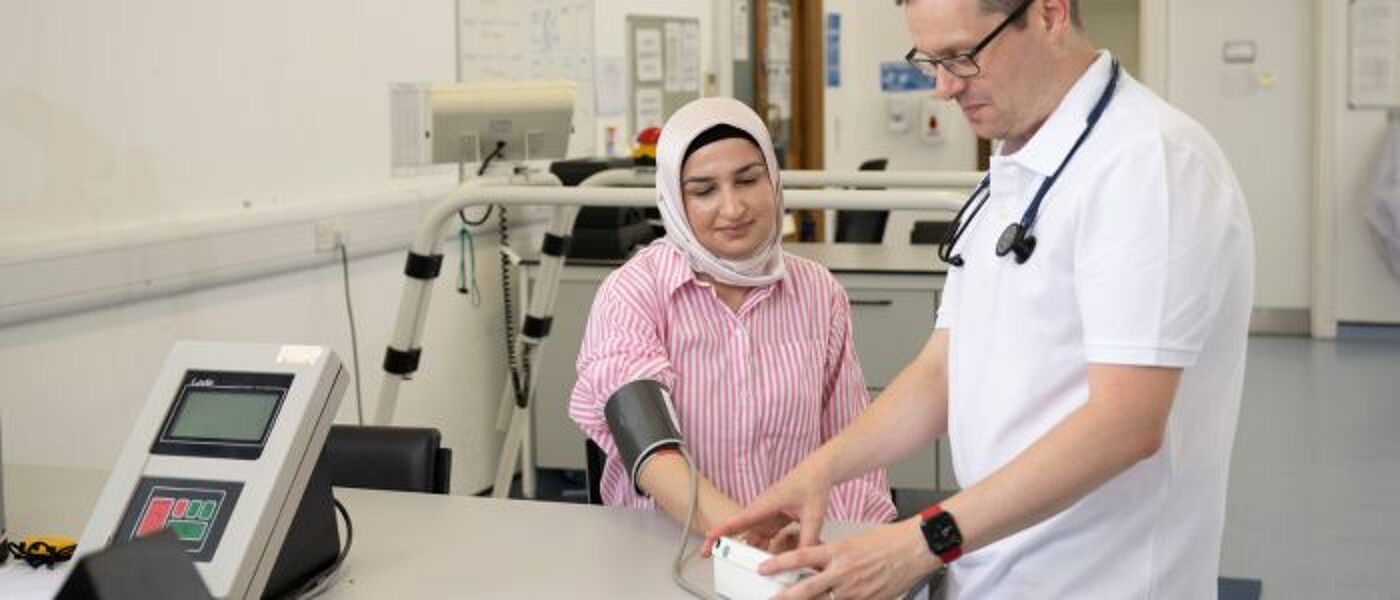 A doctor takes a patient's blood pressure in the sports lab