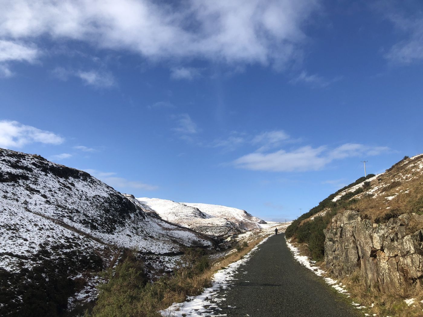 clear skies over a faintly snowy path