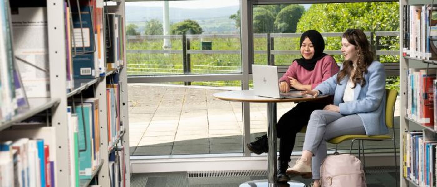 Two postgraduate researchers consulting together on the Dumfries campus