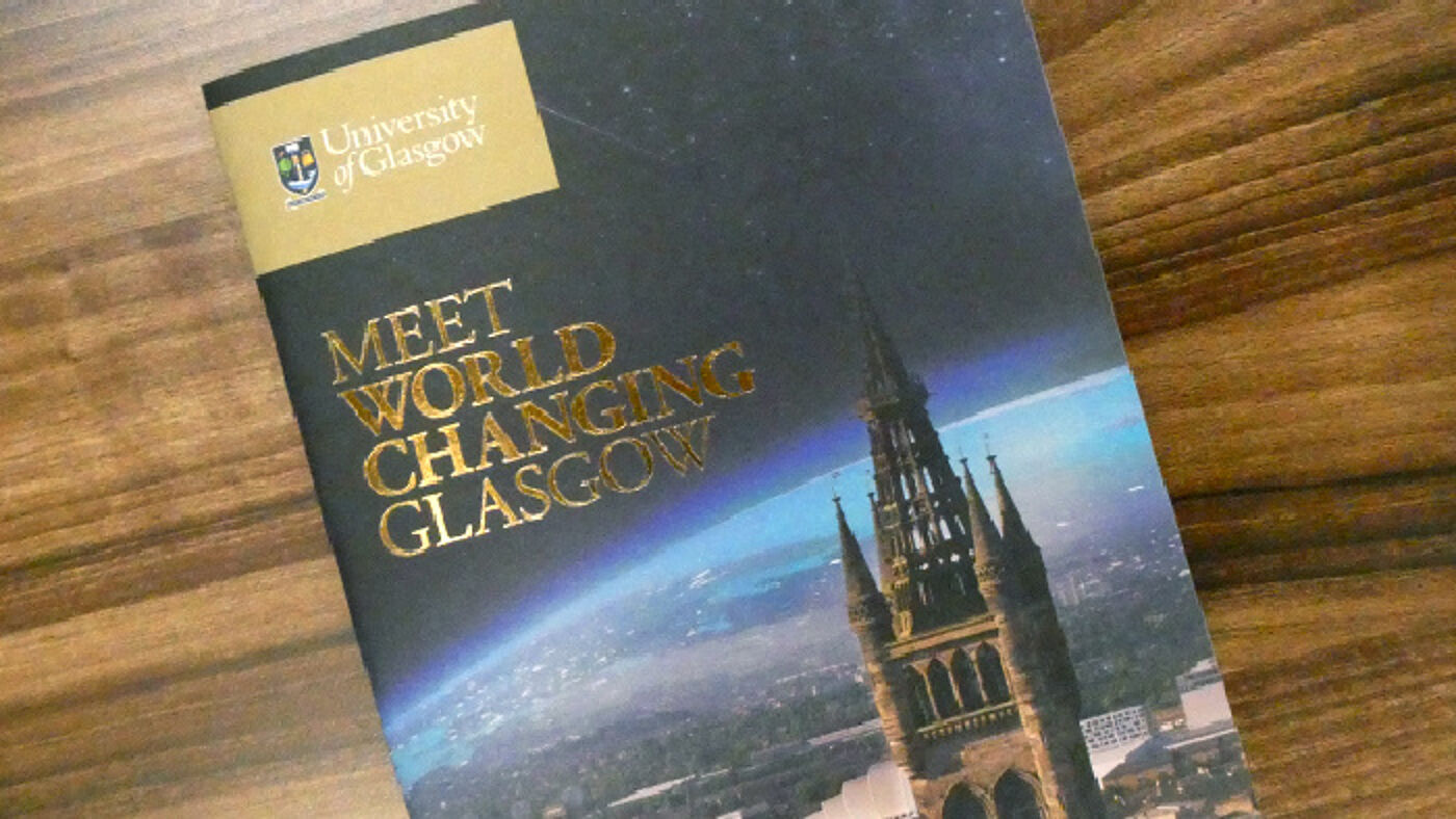 Photo of the front cover of the Meet World Changing Glasgow publication sitting on a table