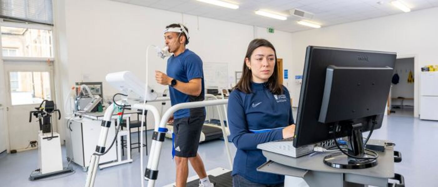 Researcher in the sports science lab using a treadmill to monitor cardiovascular rhythms