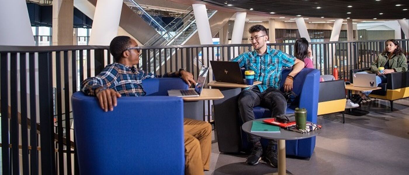 Two students sitting in a study space