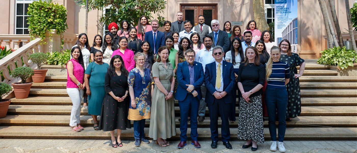Delegation of visitors from Glasgow with partners in Mumbai posing for a group shot outside a building in the sunshine