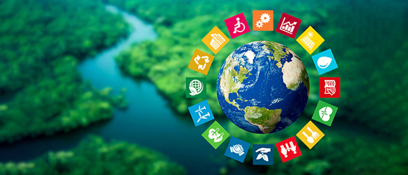 Sustainable Development Goal wheel over a grass and river view