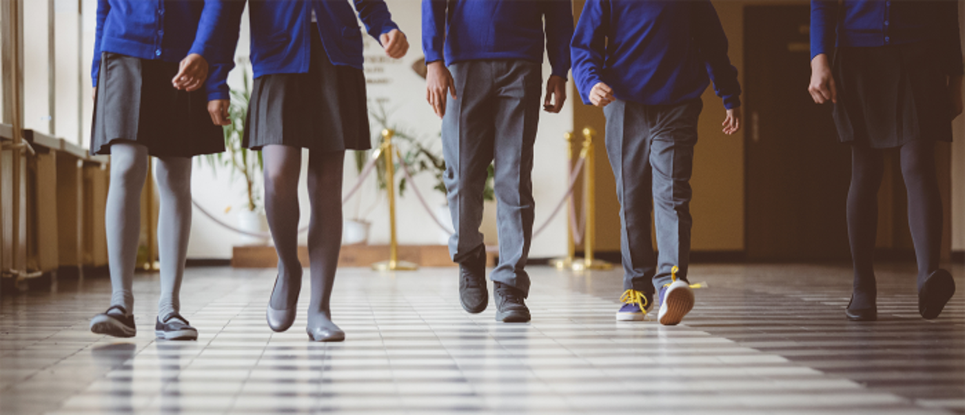 a row of students walking down a hallway