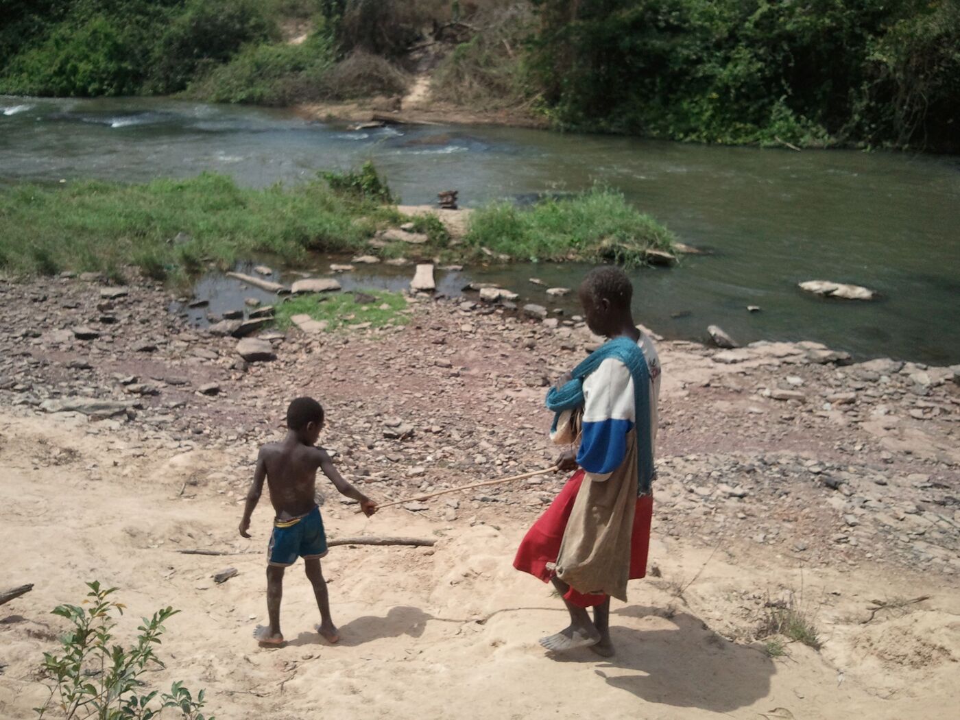 Boy leading blind man in Africa