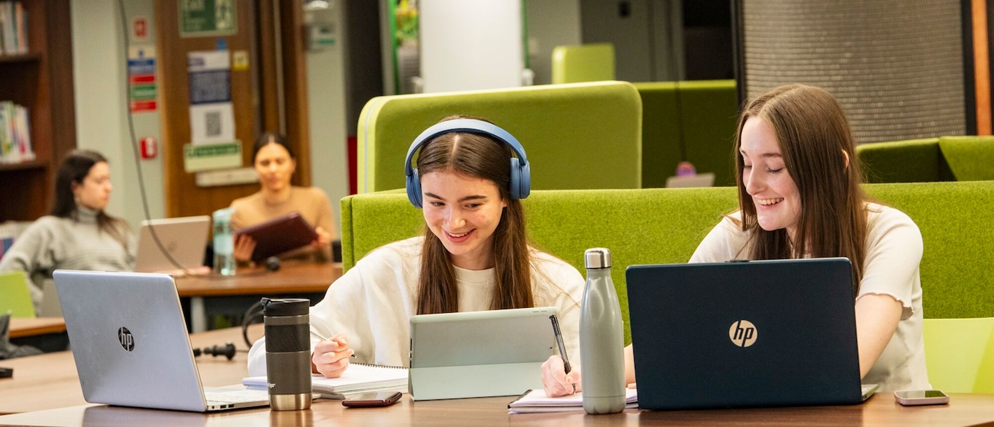 2 students studying with laptops