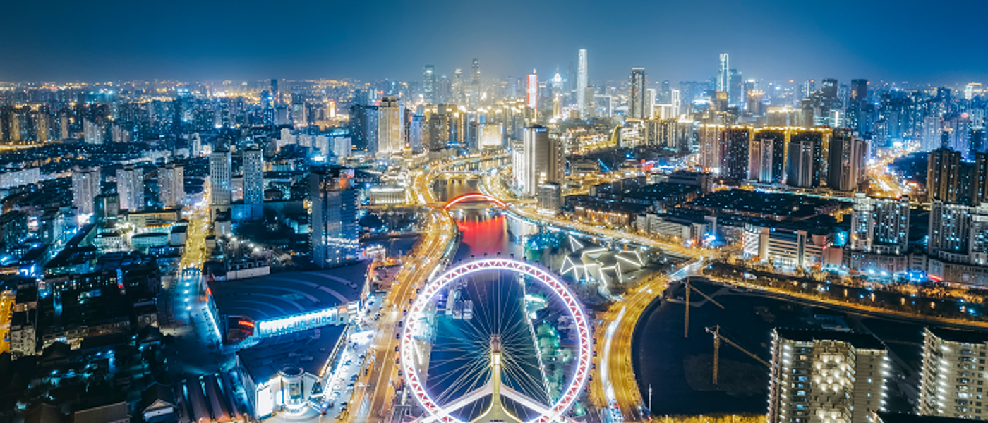 Aerial view of Tianjin at night including big wheel