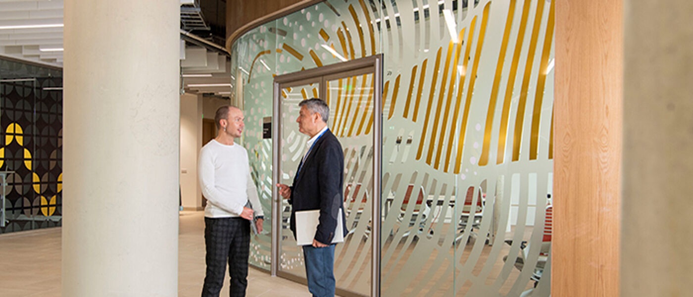 Two staff members talking at the university