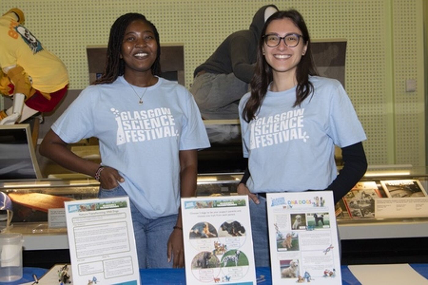 Person sitting at a table with people colouring in