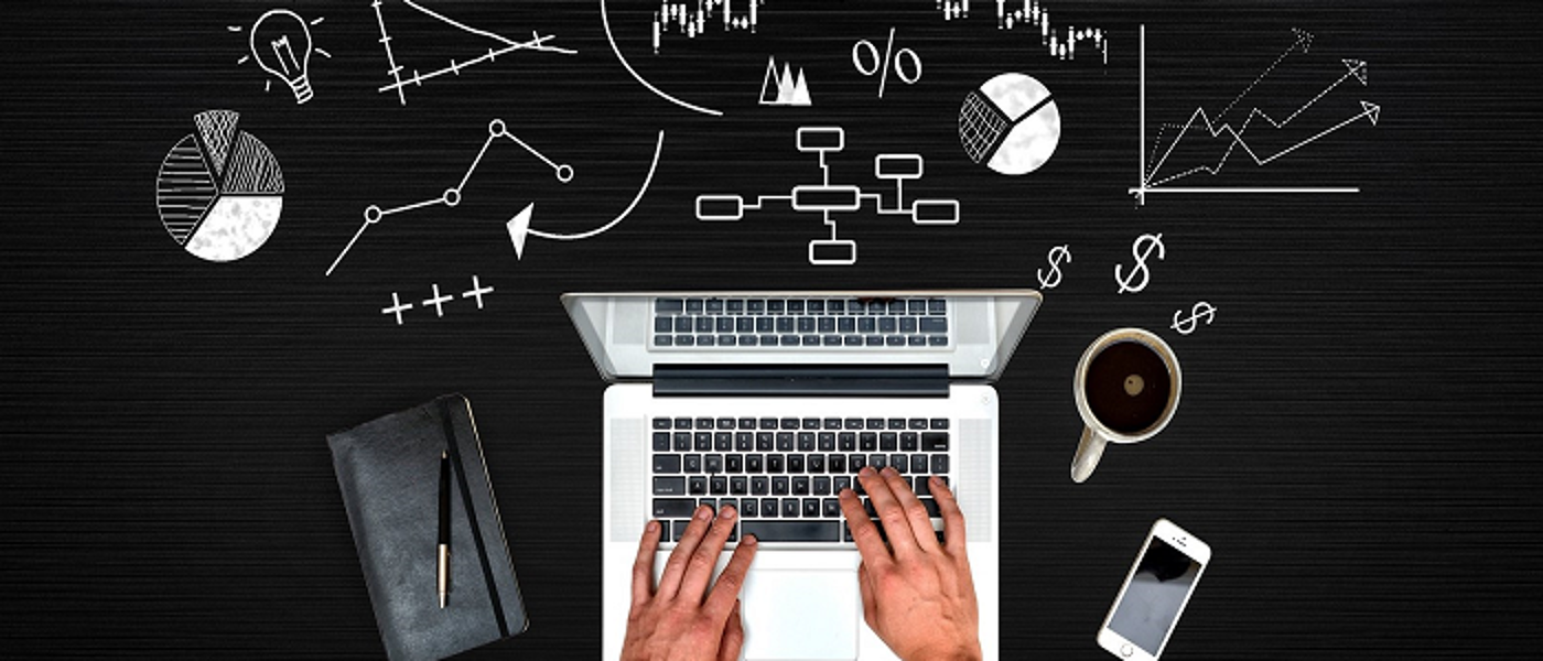 Hands typing on keyboard with illustration of different charts and grafts around it
