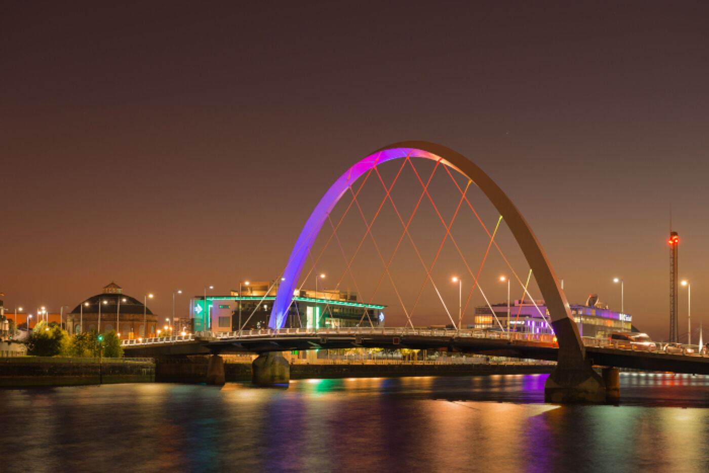 Night time view of the Clyde with the Clyde Arc at the centre lit up in purple