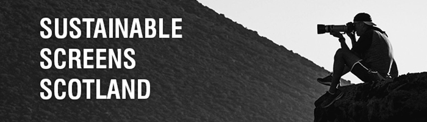 A photograph with a photographer with a long telephoto lens sitting down to take a photograph of a barren landscape with the text Sustainable Screens Scotland overlayed.