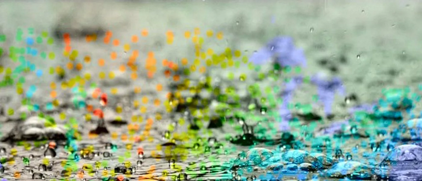Rain puddles with rainbow colours
