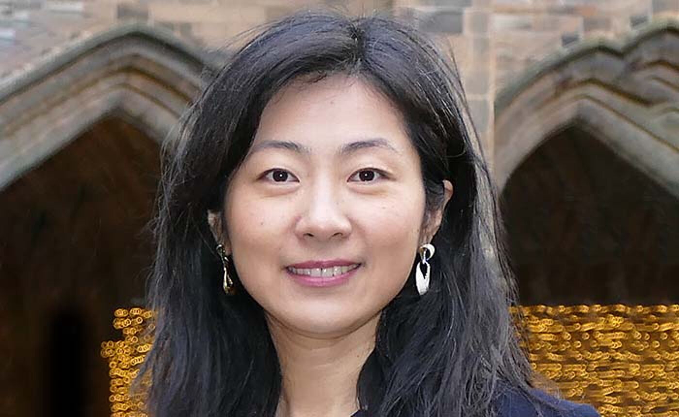 Dr Xiang Li standing in the quadrangle the University of Glasgow
