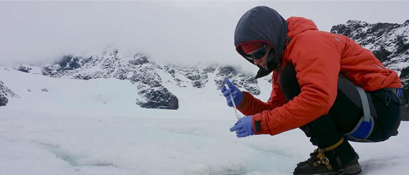 Researcher collecting samples in Arctic during fieldwork