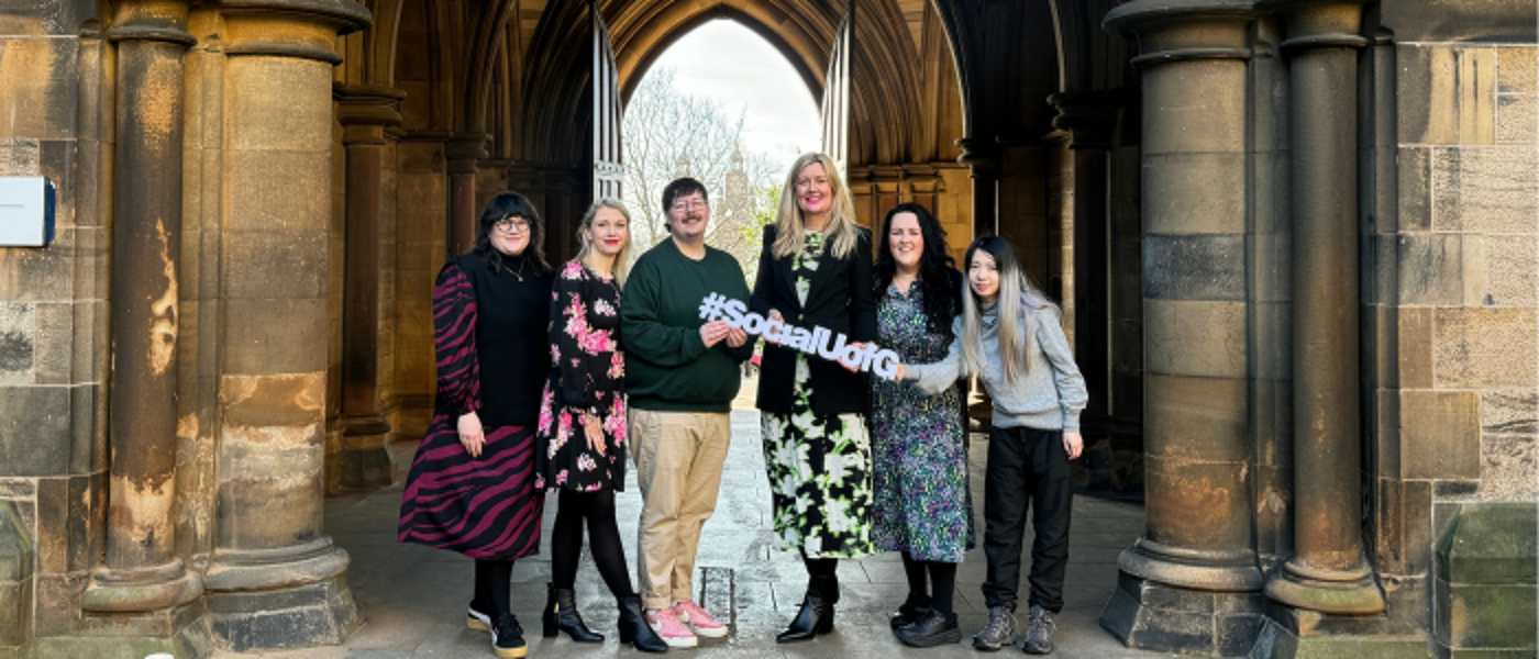 A group of people standing under an archway in the east quad