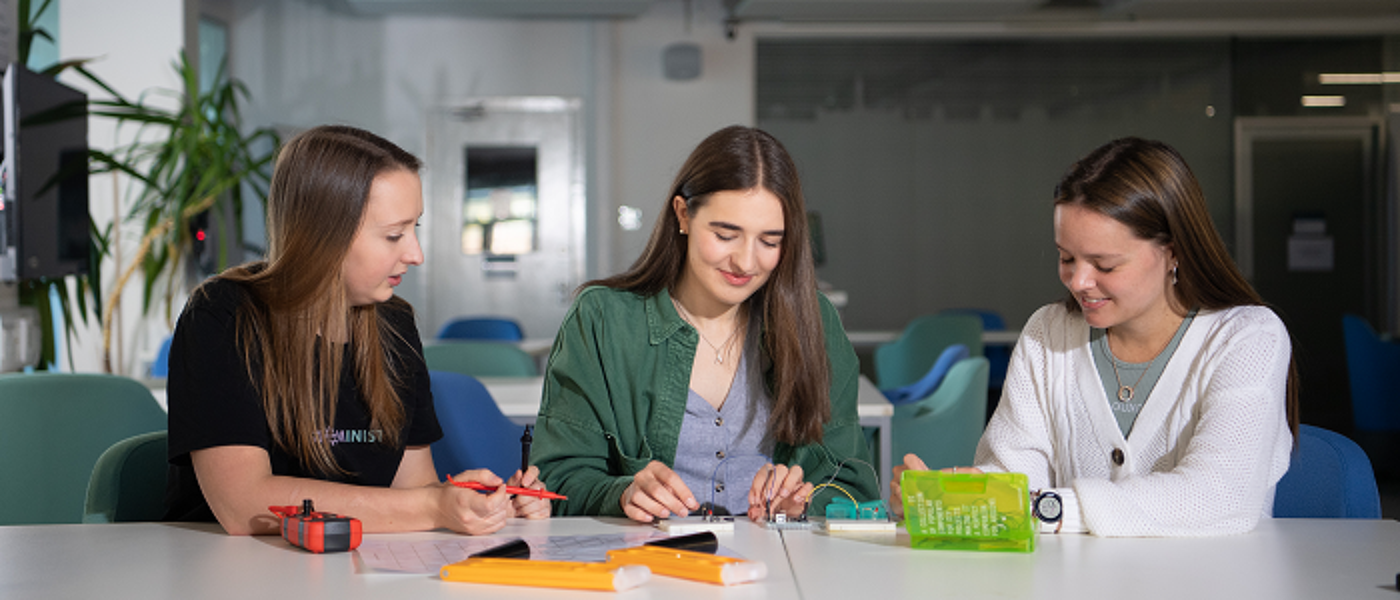 Female engineering student sitting at a table in a row