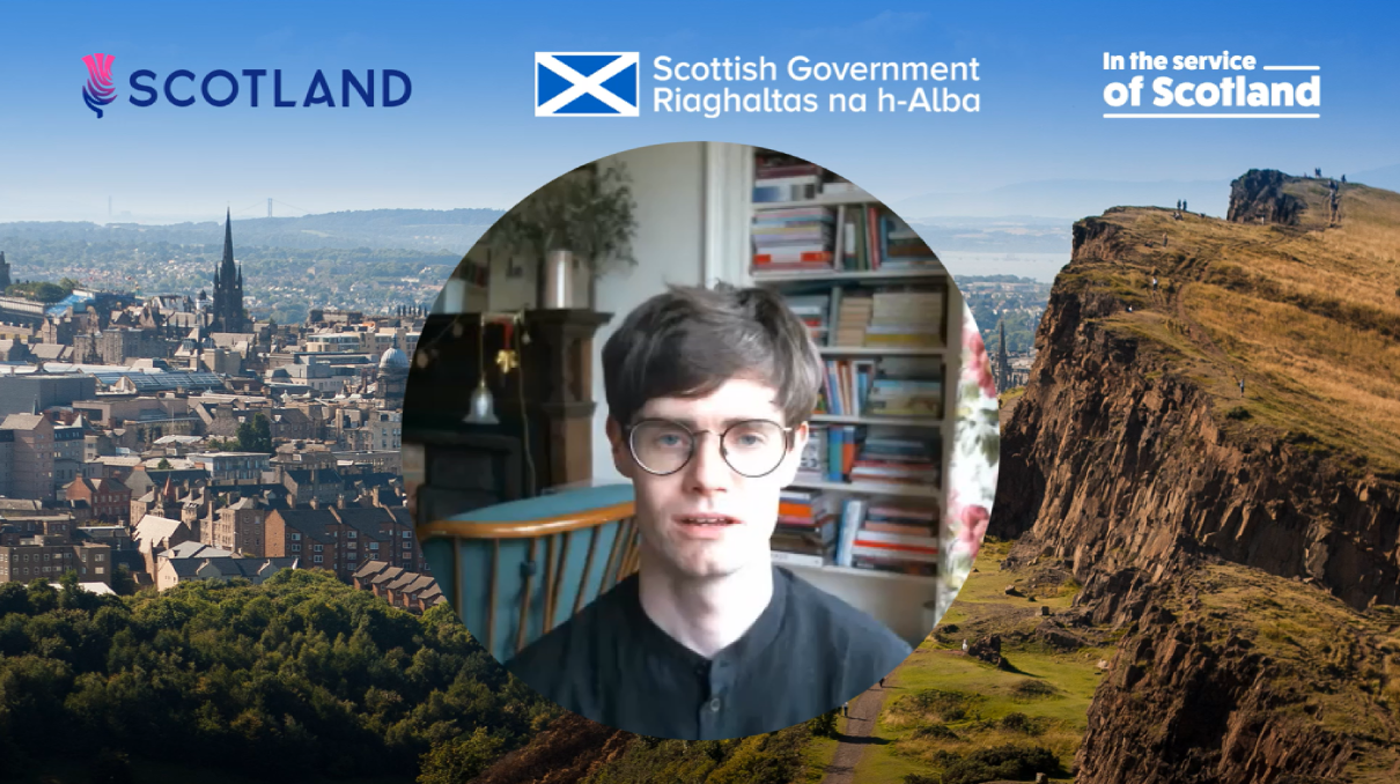Man facing forward inside a circle with backdrop of Edinburgh and Scottish Government Logos along the top of the image