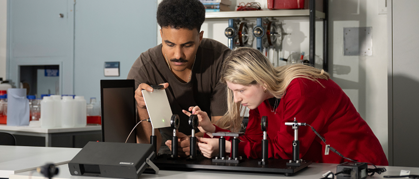 Two physics students conducting research