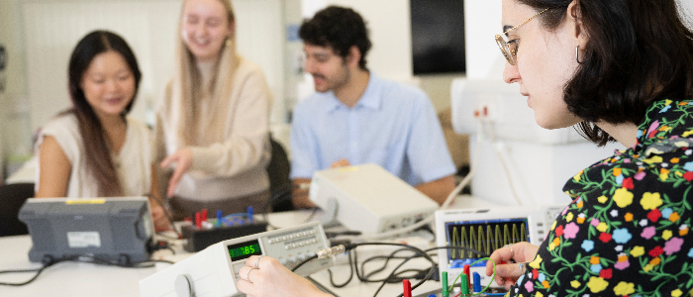 Four students working together on physics research