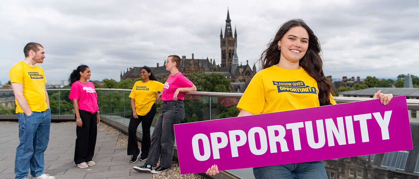 Student holding a banner for giving day