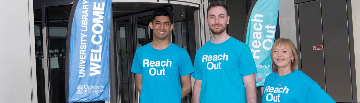 Reach Out staff standing outside the library building