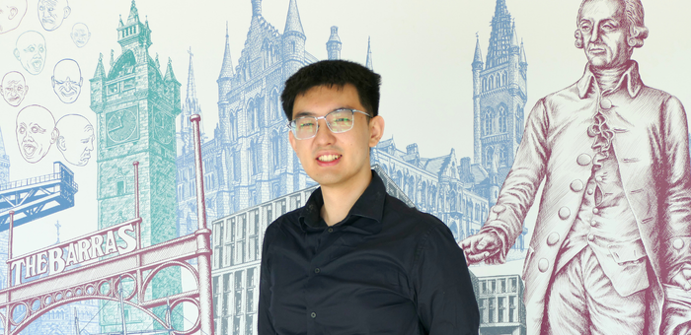 International student with Adam Smith Business School Mural