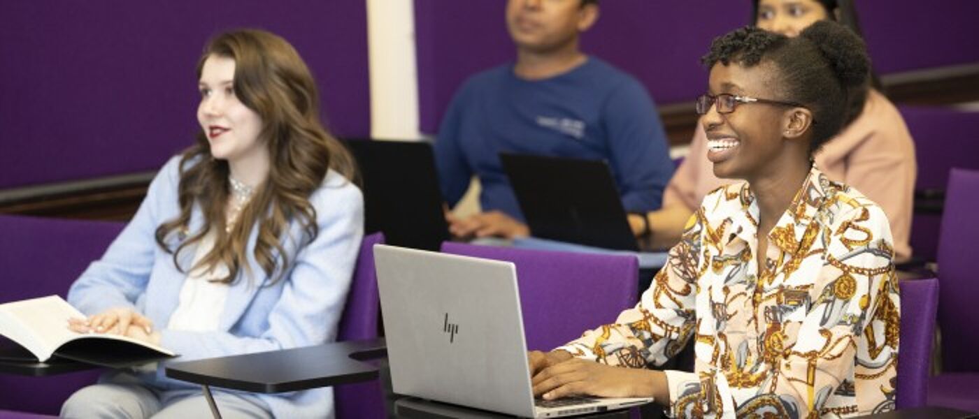 Dumfries students sitting in lecture smiling
