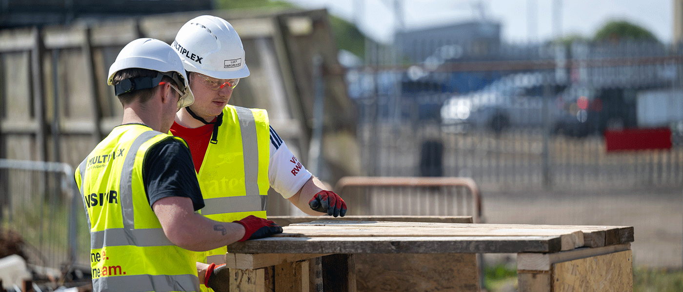 Two men in hard hats and high vis vests