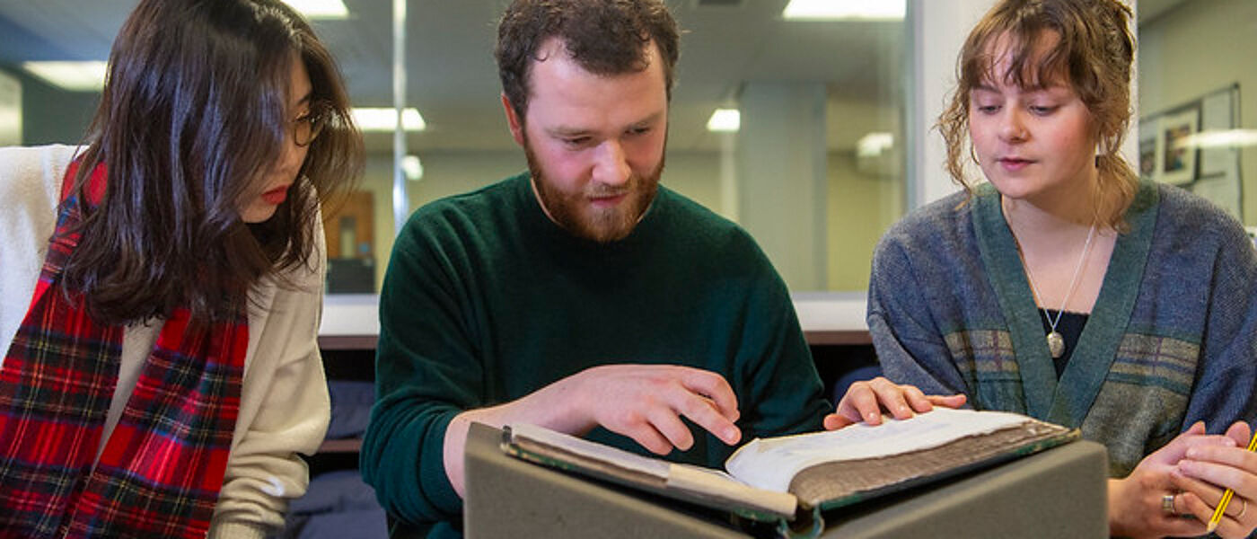 3 students in the university's special collections library