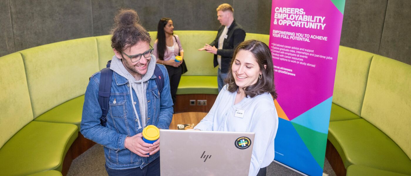 Employers and students speaking in green booth in Library