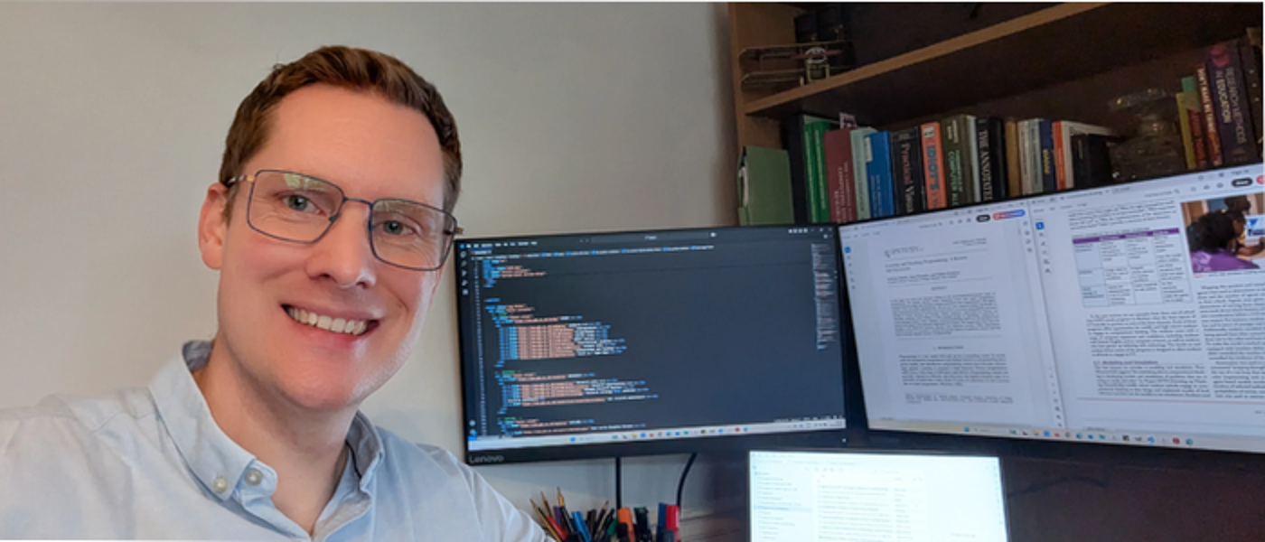 Alistair Surrall sat at a dual monitor computer