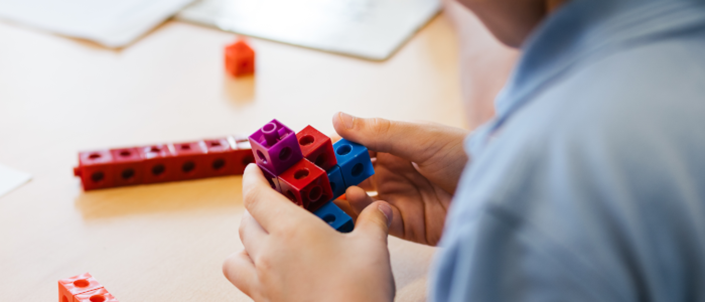 a child creating a cube-based construction