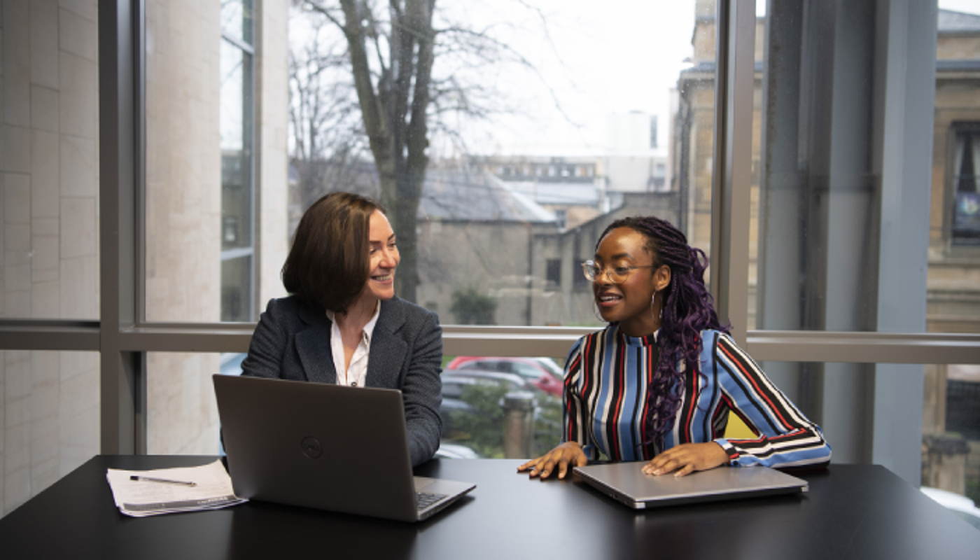 A member of staff from Student Services interviews a student.