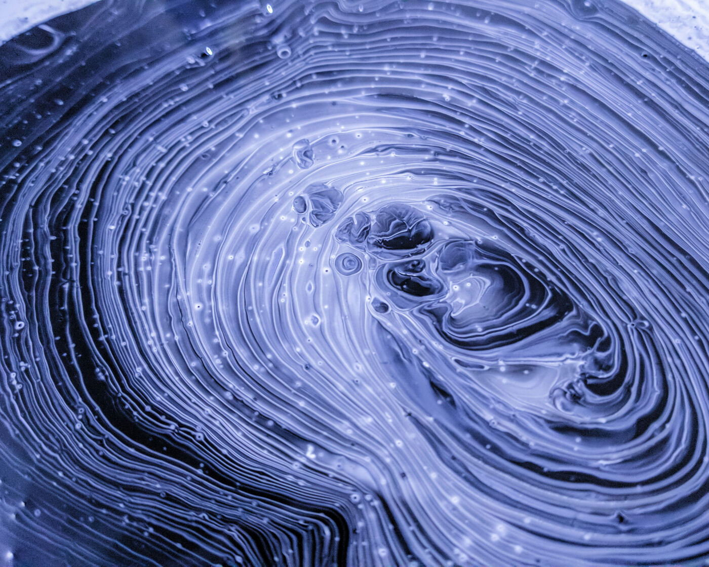 This picture shows an abstract ripple of purple liquid