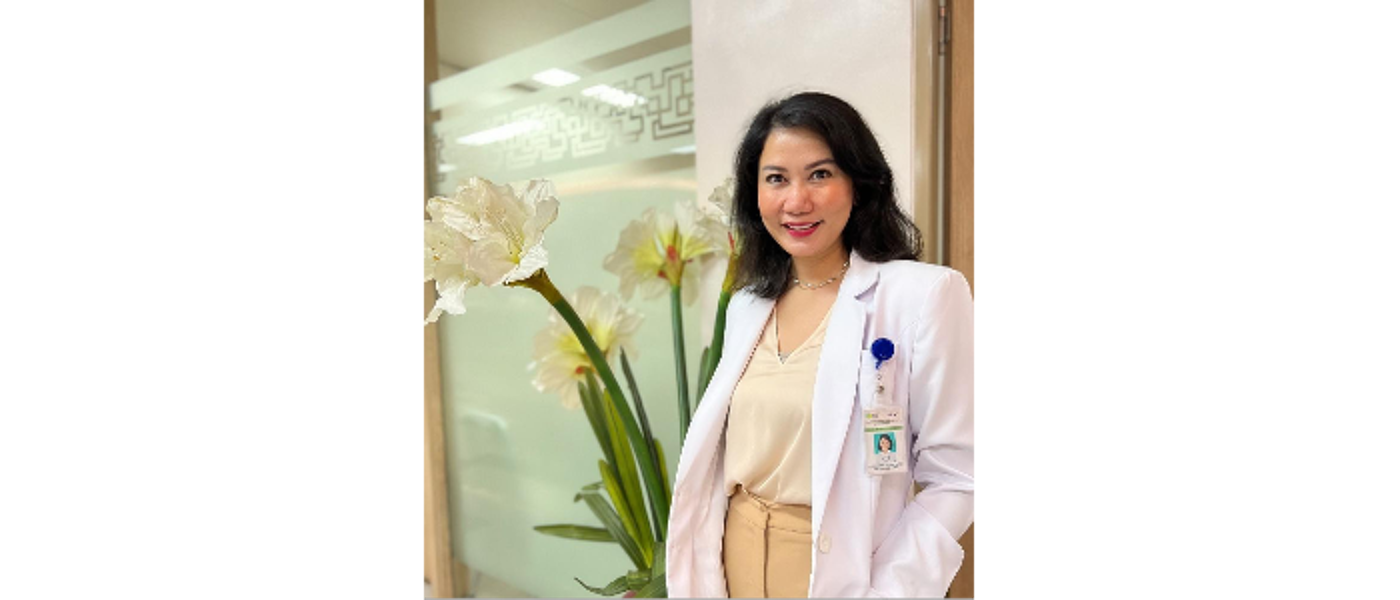 Kristiana Siste, smiling at camera